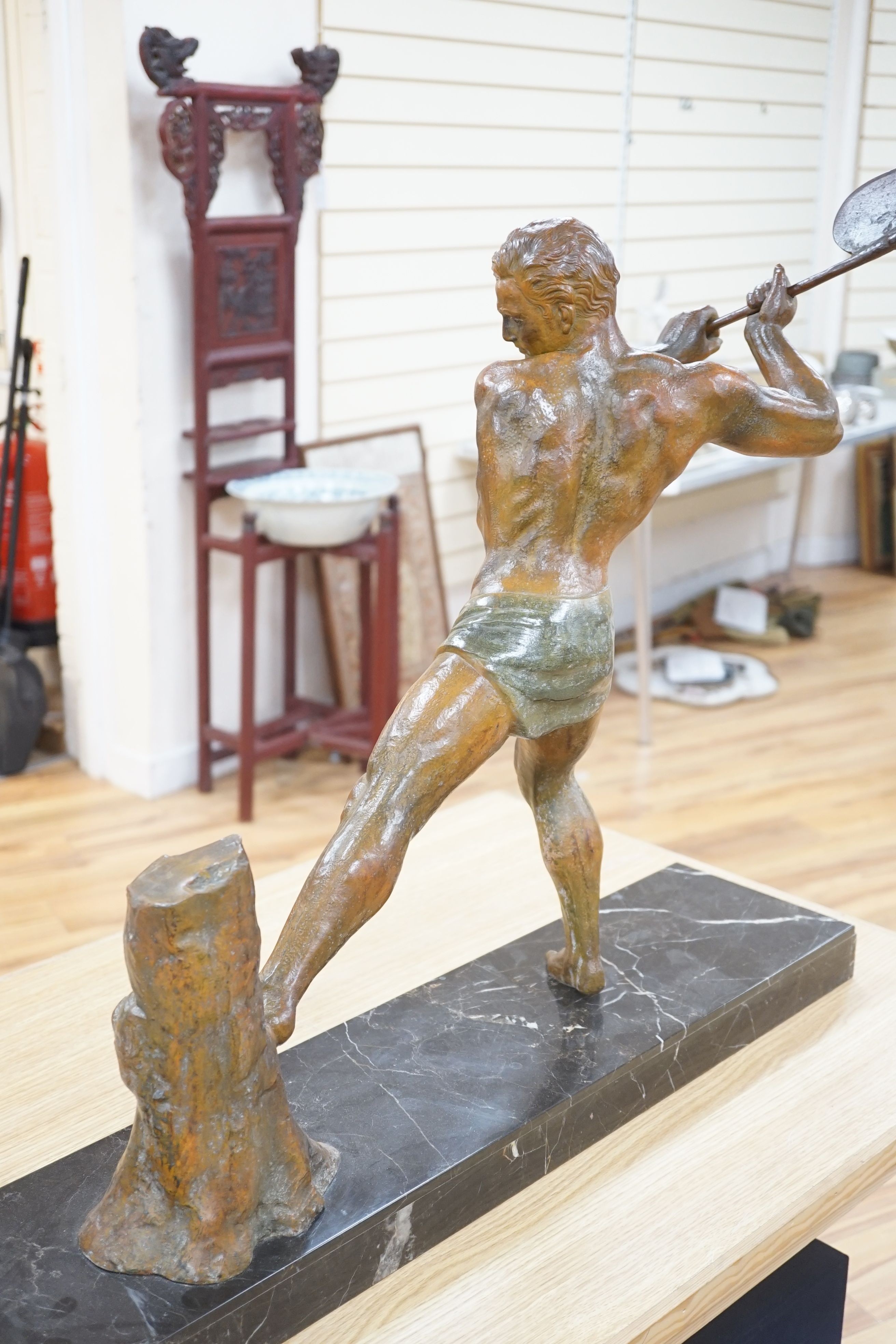 An Art Deco bronzed metal woodcutter, signed G Hervore, 75cm long